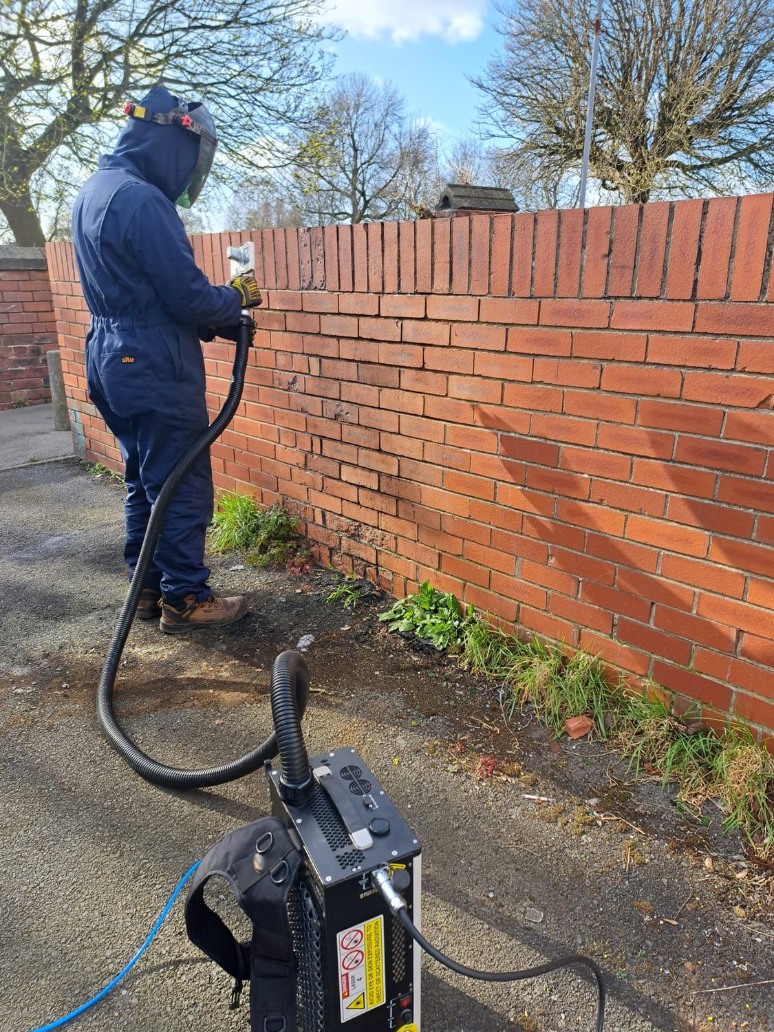 Laser cleaning a brick wall