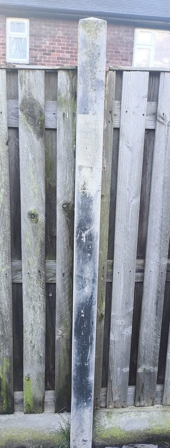 Weathered, stained concrete post before cleaning
