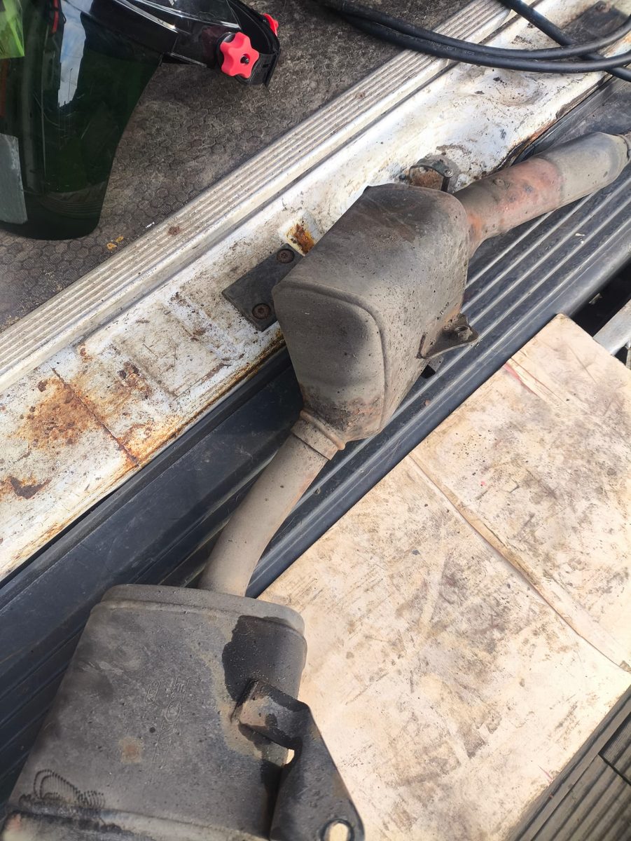 Rusty exhaust and vehicle sill before laser rust removal
